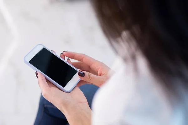 Cropped photo of woman holding her digital device in hands