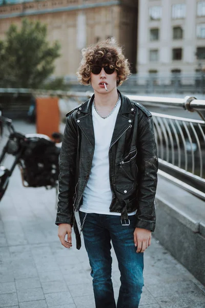Unga lockiga Rocker Walking med cigarett i munnen — Stockfoto