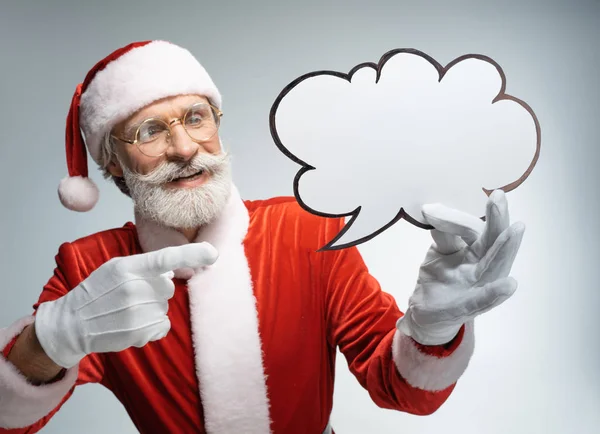Père Noël pointant vers bulle de rayons dans la main — Photo