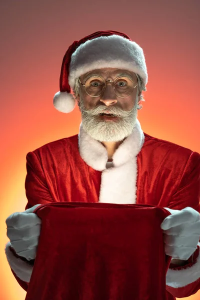 Père Noël âgé tenant sac avec des cadeaux dans les mains — Photo