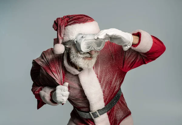 Santa Claus in frozen protective glasses holding sack — Stock Photo, Image