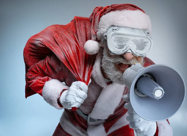 Elderly Santa Claus with sack speaking at megaphone — Stock Photo, Image