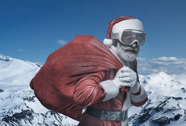 Senior Santa Claus in mountains with sack — Stock Photo, Image