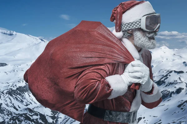 Santa Claus in mountains with sack full of presents — Stock Photo, Image