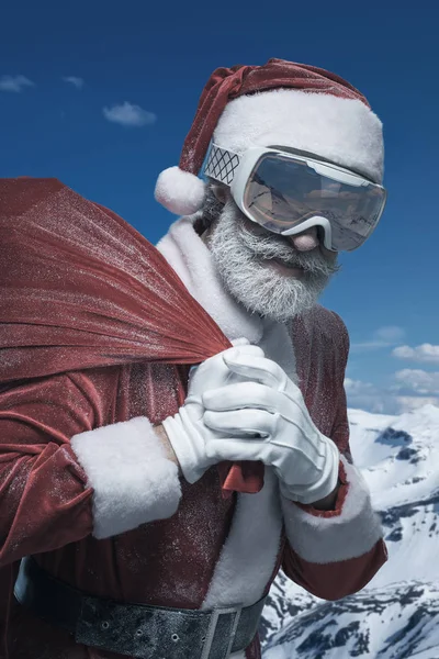 Santa Claus in mountains with sack full of presents — Stock Photo, Image