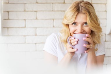 Mutlu güzel kadın sıcak içecek içiyor