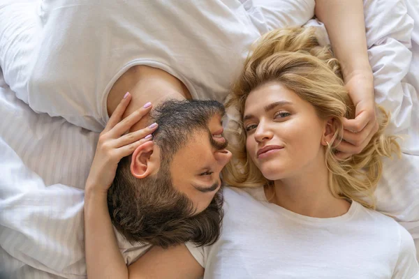 Pretty young lady is lying in bed — Stock Photo, Image