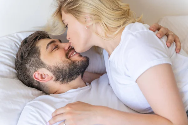 Pretty young lady is kissing her boyfriend — Stock Photo, Image
