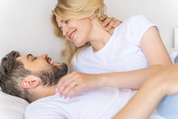 Happy couple is lying in the bed at home — Stock Photo, Image