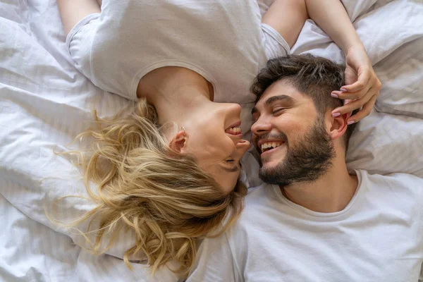 Lieve jonge paar is lachen in de slaapkamer — Stockfoto