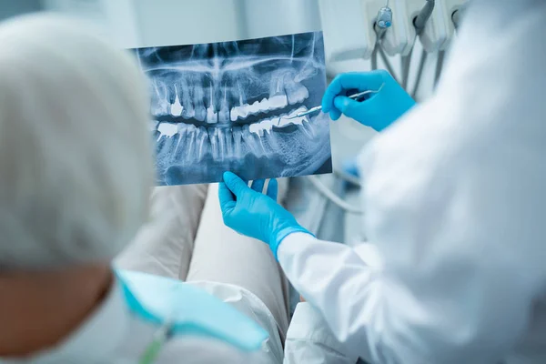 Dentista discute radiografía de paciente femenino en clínica — Foto de Stock