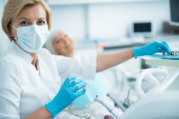 Doctor in sterile gloves posing at camera — Stock Photo, Image