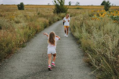 Küçük Beyaz kız açık havada yolda yürüyor