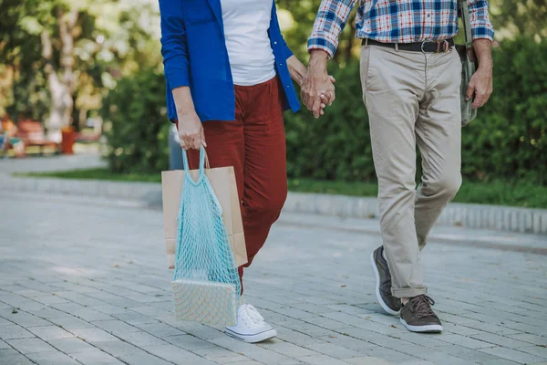 Man and woman walking and holding hands stock photo — Stock Photo, Image