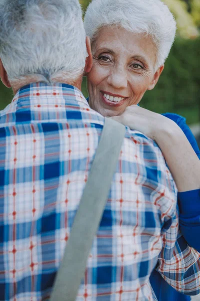 Blij volwassen vrouw knuffelen haar man stockfoto — Stockfoto