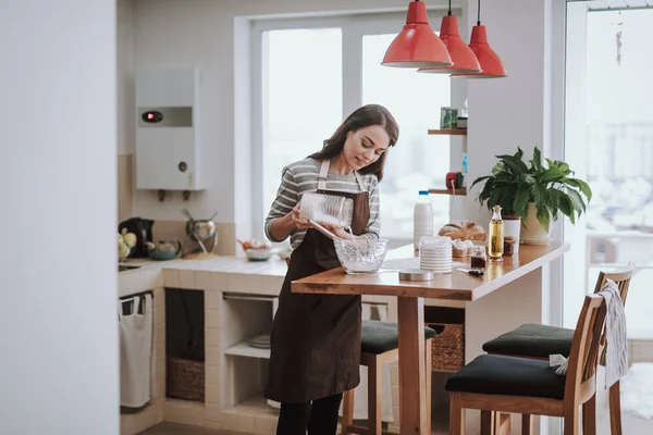 Merry lady is enjoying cooking at home — Stock Photo, Image