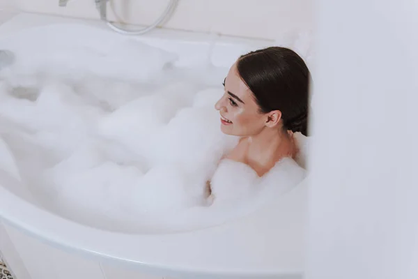 Mulher atraente alegre desfrutando de banho de espuma no fim de semana — Fotografia de Stock