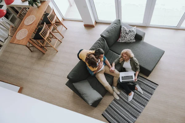 Loving parents spending time with their cute daughter at home