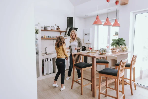 Cheerful mother and daughter having fun at kitchen — Stock Photo, Image