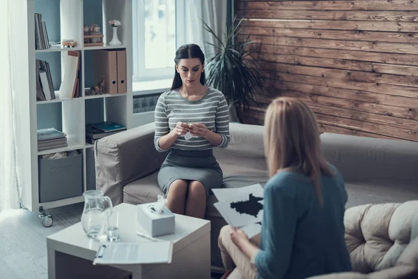 Female psychologist analyzing psycological test for patient in therapy cabinet — Stock Photo, Image