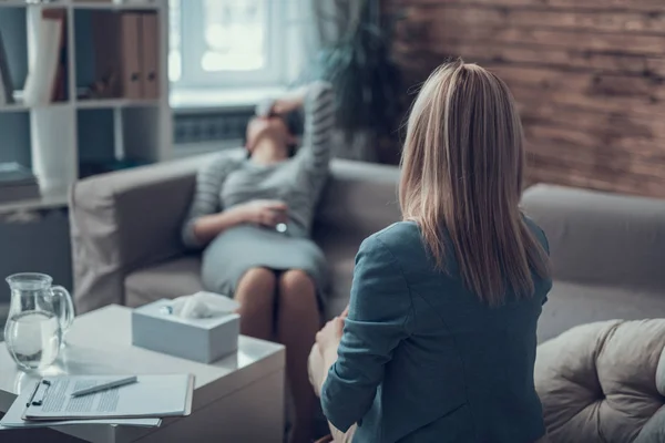 Vista posteriore del medico che lavora con il paziente in una sala di consultazione privata — Foto Stock