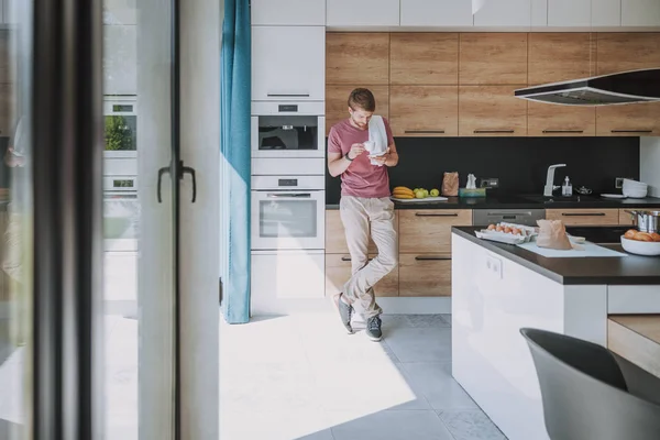 Junger Mann beginnt seinen Tag in der Küche — Stockfoto