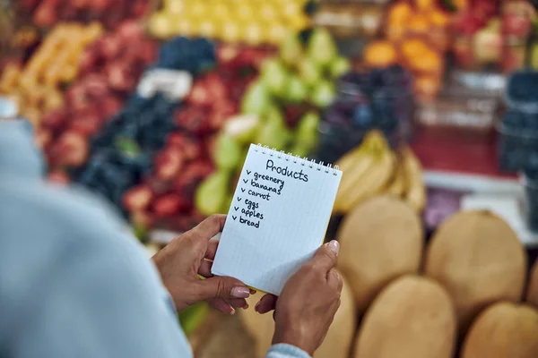 Shopping list in hands of woman stock photo — Stock Photo, Image