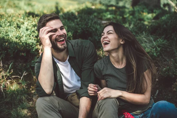 Unga älskare par som har vila på grön kulle — Stockfoto