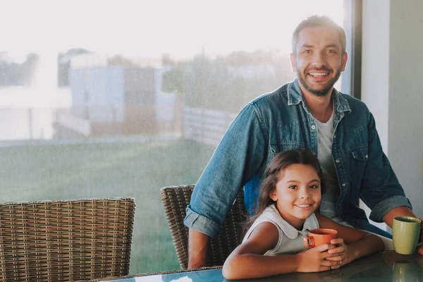 Fröhlich liebender Vater trinkt Tee mit seiner Tochter — Stockfoto