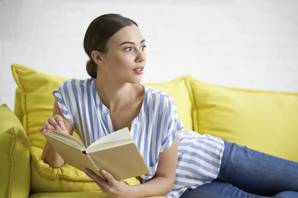 Woman with book looking away stock photo