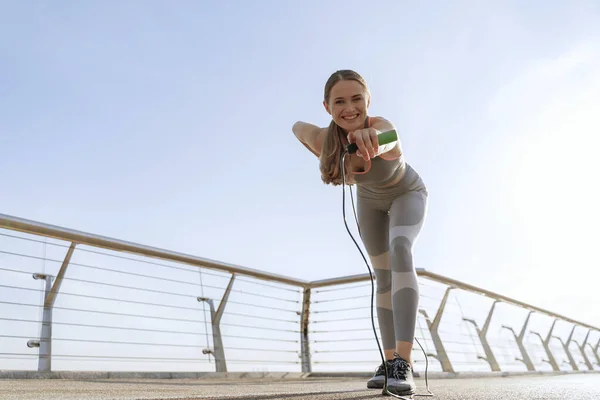 Senhora feliz com corda de salto apontando na câmera — Fotografia de Stock