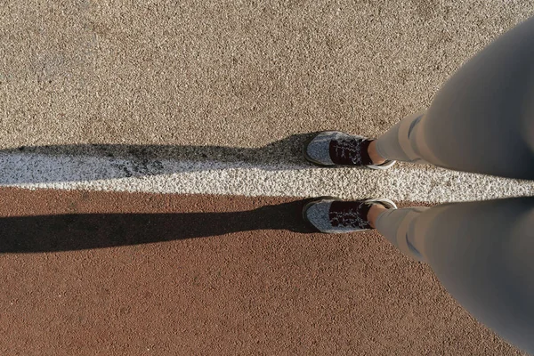 Kadın sportif bacaklar yol ortasında kalıyor.