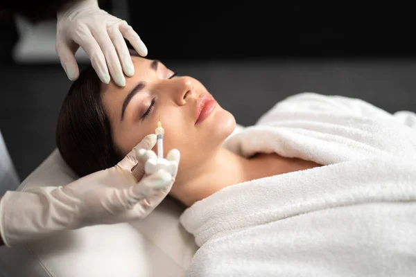 Encantadora joven recibiendo inyecciones de belleza en el salón de spa — Foto de Stock