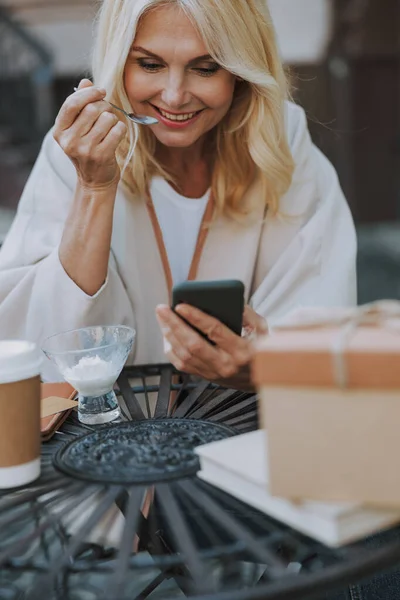 Female looking at her cellphone in a cafe