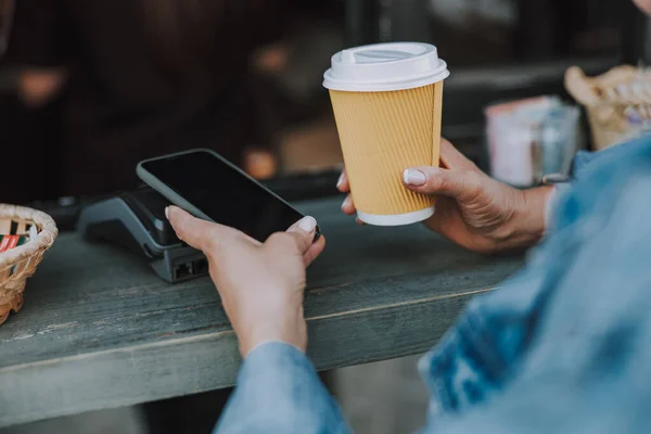 女性は屋外でコーヒーを1杯買う — ストック写真