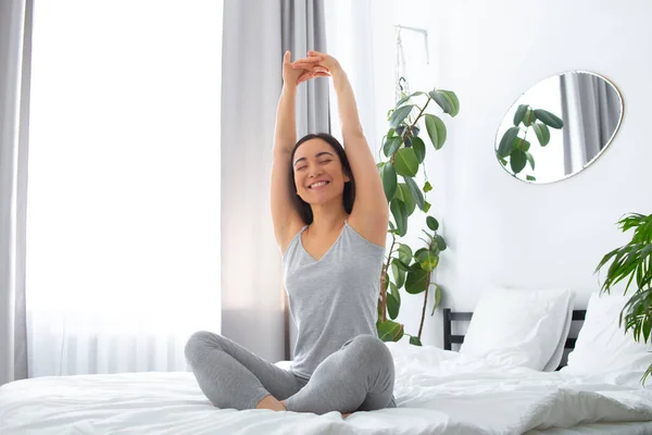 Young woman feeling happy after waking up — Stockfoto