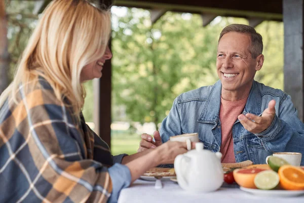 Merry loving spouses enjoying time together during breakfast outdoors — Stock Photo, Image