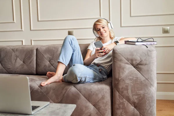 Joven hembra contenta relajándose en casa con música favorita — Foto de Stock