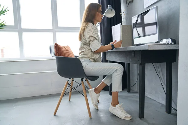 Evden internet üzerinden çalışan güzel genç bir iş kadını.