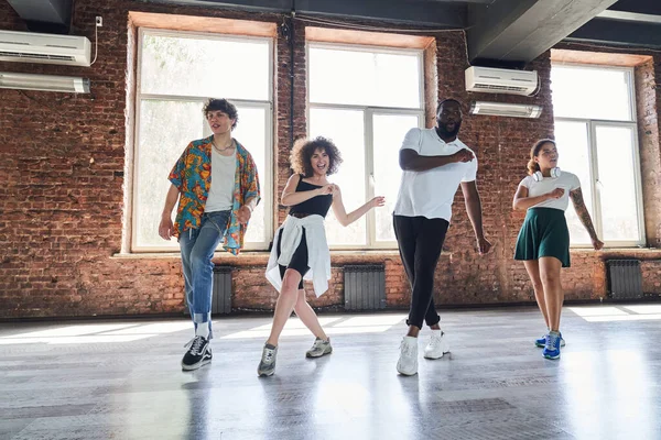 Happy young people dancing together in sport hall — Stock Photo, Image