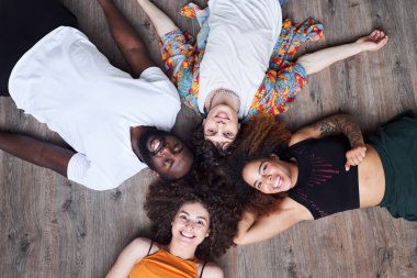 Gülümseyen arkadaşlar dans stüdyosunda dinleniyorlar.