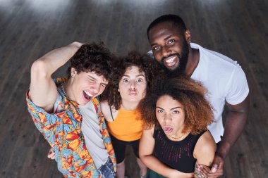 Erkek arkadaşlarının yanında yüzünü buruşturan iki kadın.