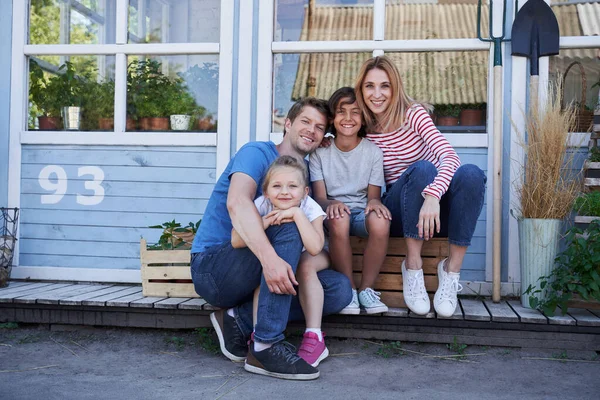 행복 한 사랑많은 가족이 집 밖에 앉아 있다 — 스톡 사진