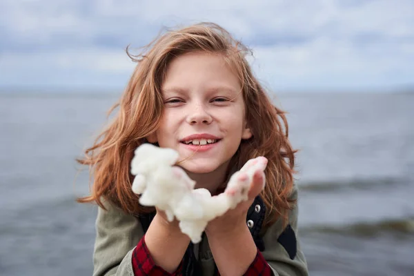 Girl holds sea foam