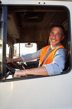 Portrait of delivery driver in the car clipart