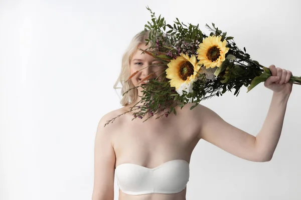 Vreugdevolle jonge vrouw met boeket met zonnebloemen — Stockfoto