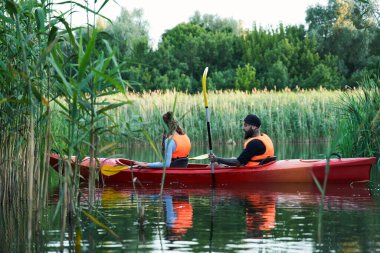 Nehirde rafting yapan çift.