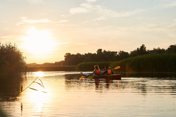 Beautiful couple kayaking on river together