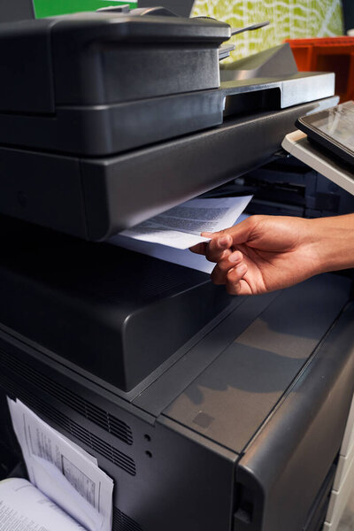 Man is placing a document on scanner