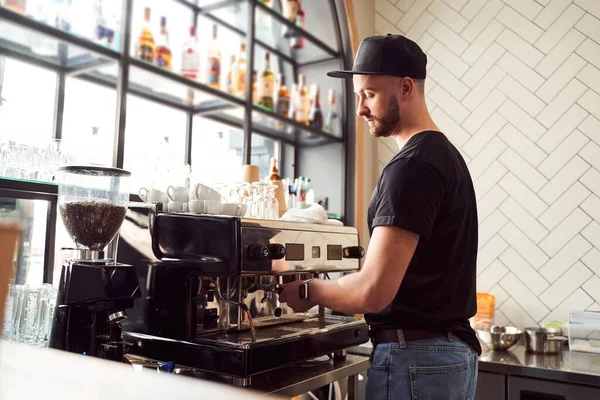 Varón barista trabajando en la máquina de café —  Fotos de Stock
